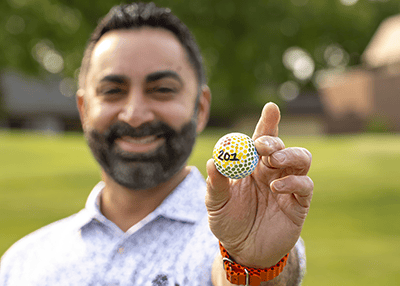 Golfer holding golf ball image